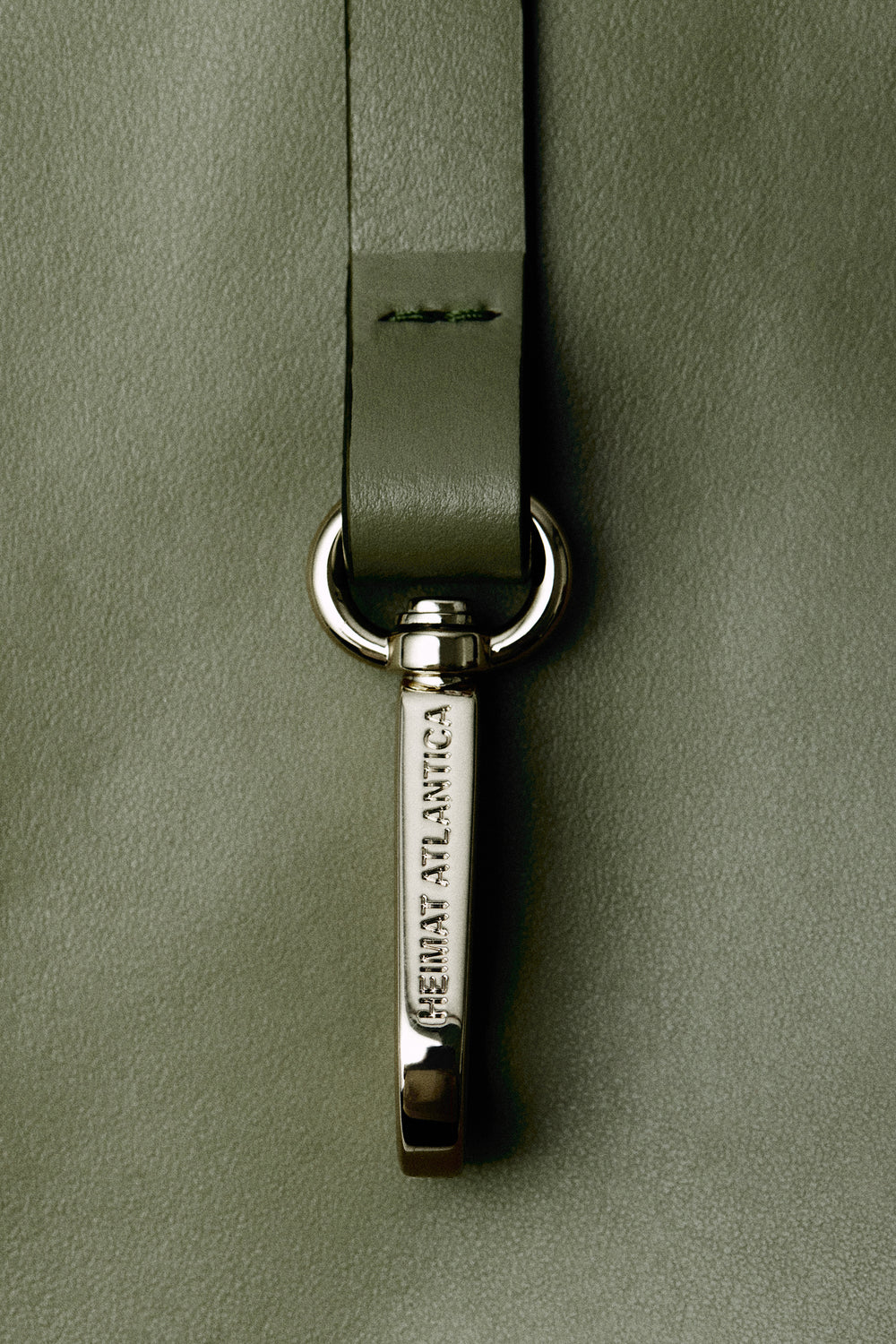 Slim olive Heimat strap with personalized golden hardware with olive leather detail. 