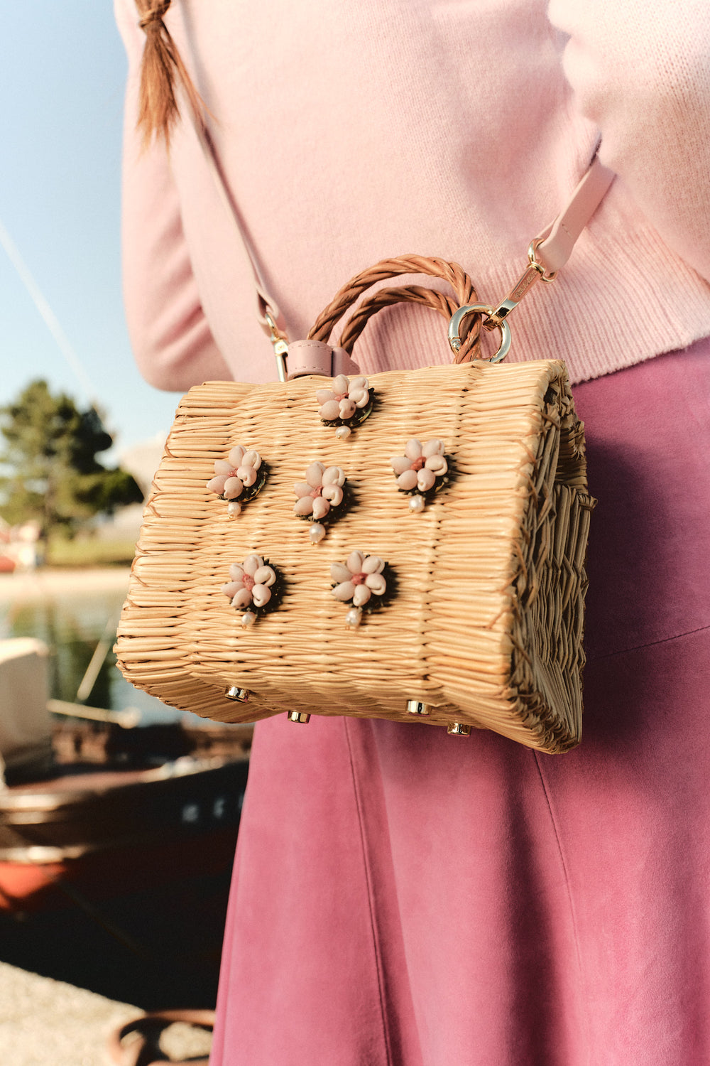Shella Vallentines Pink limited edition basket bag by Heimat Atlantica, woven in Portugal and finished in Spain with a blush pink Atlantic shell centerpiece in a model with the view of the Atlantic Coast.