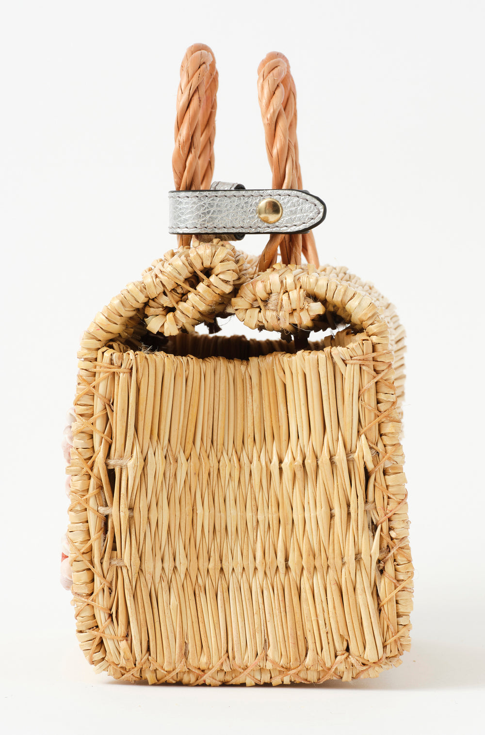 Shella Mini Silver basket bag by Heimat Atlantica, handwoven in Portugal from reed and finished in Spain with an Atlantic shell charm.  Lateral detail. 