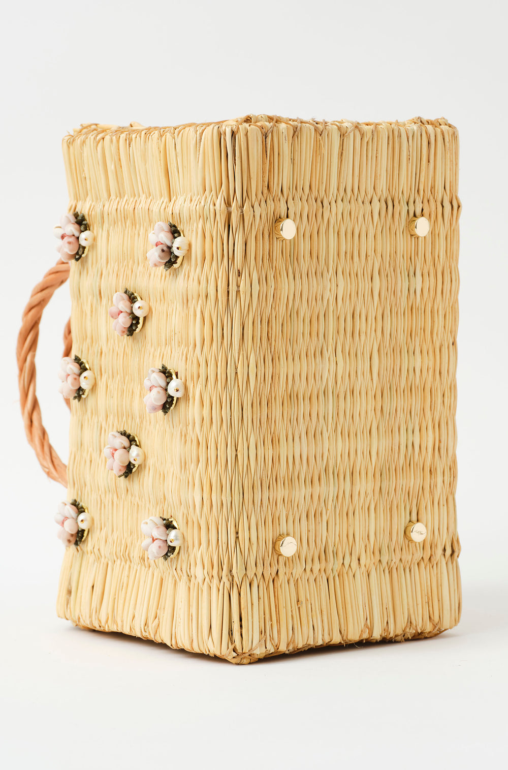 Wicker handbag with braided handle, light pink strap, and pastel floral decorations with pearl from the atlantic and leather in blush pink golden feet details