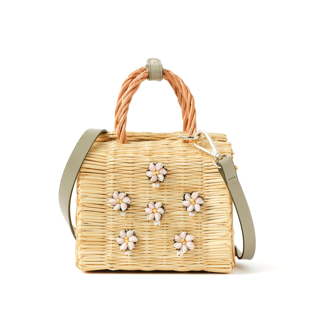 Mini Shella Valenitnie's basket bag by Heimat Atlantica, handwoven in Portugal from reed and finished in Spain with an Atlantic shell detail. General View with strap.