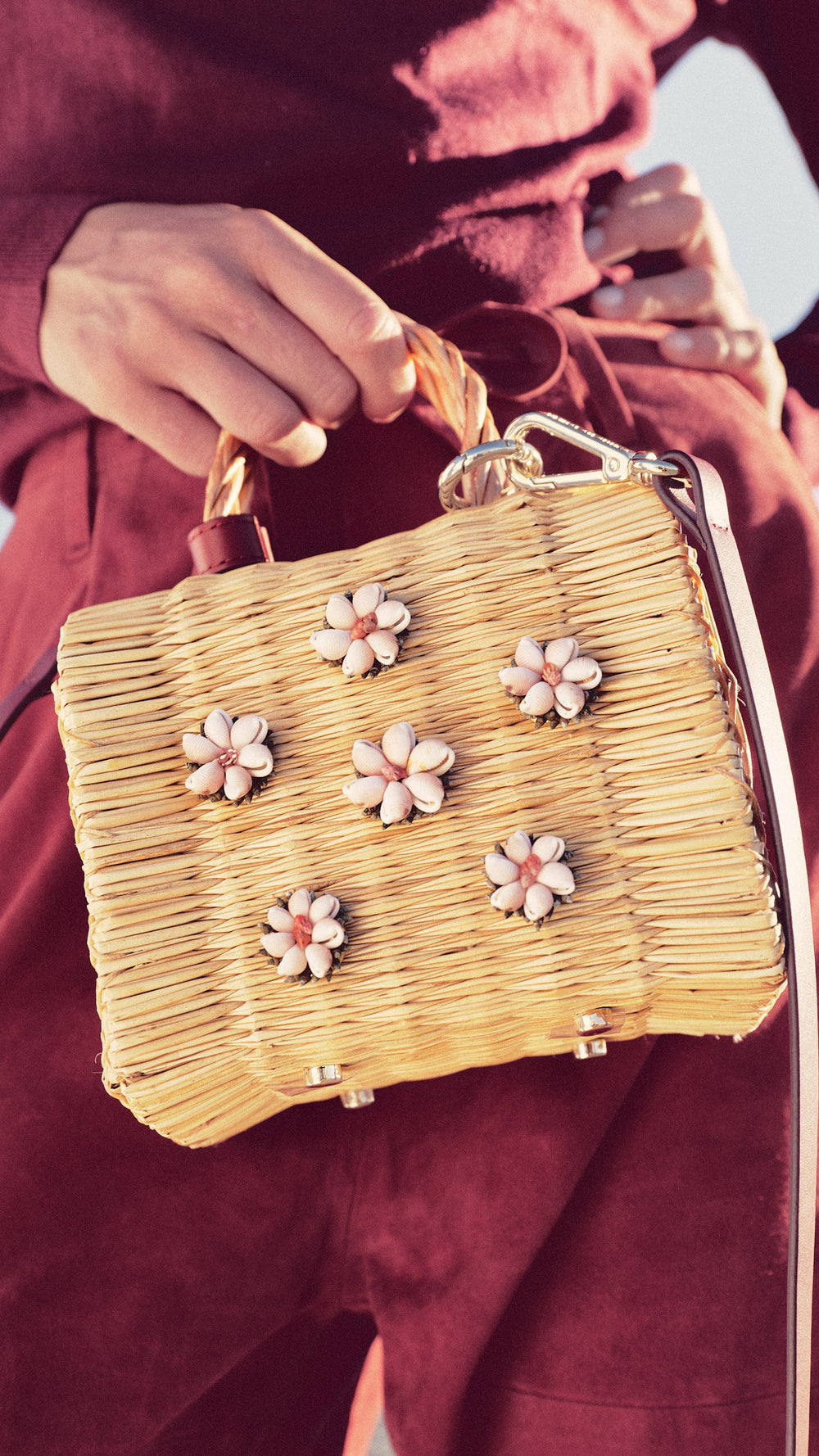 Shella Burgundy Collector’s Edition by Heimat Atlantica, handwoven in Portugal and finished in Spain with an Atlantic shell centerpiece in model photograph in the Atlantic Coast. 