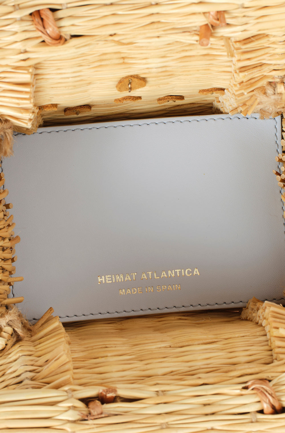 Shella Sky Atlantic Ice basket bag by Heimat Atlantica, handwoven in Portugal and finished in Spain with a pink Atlantic shell and hand embroidery.
