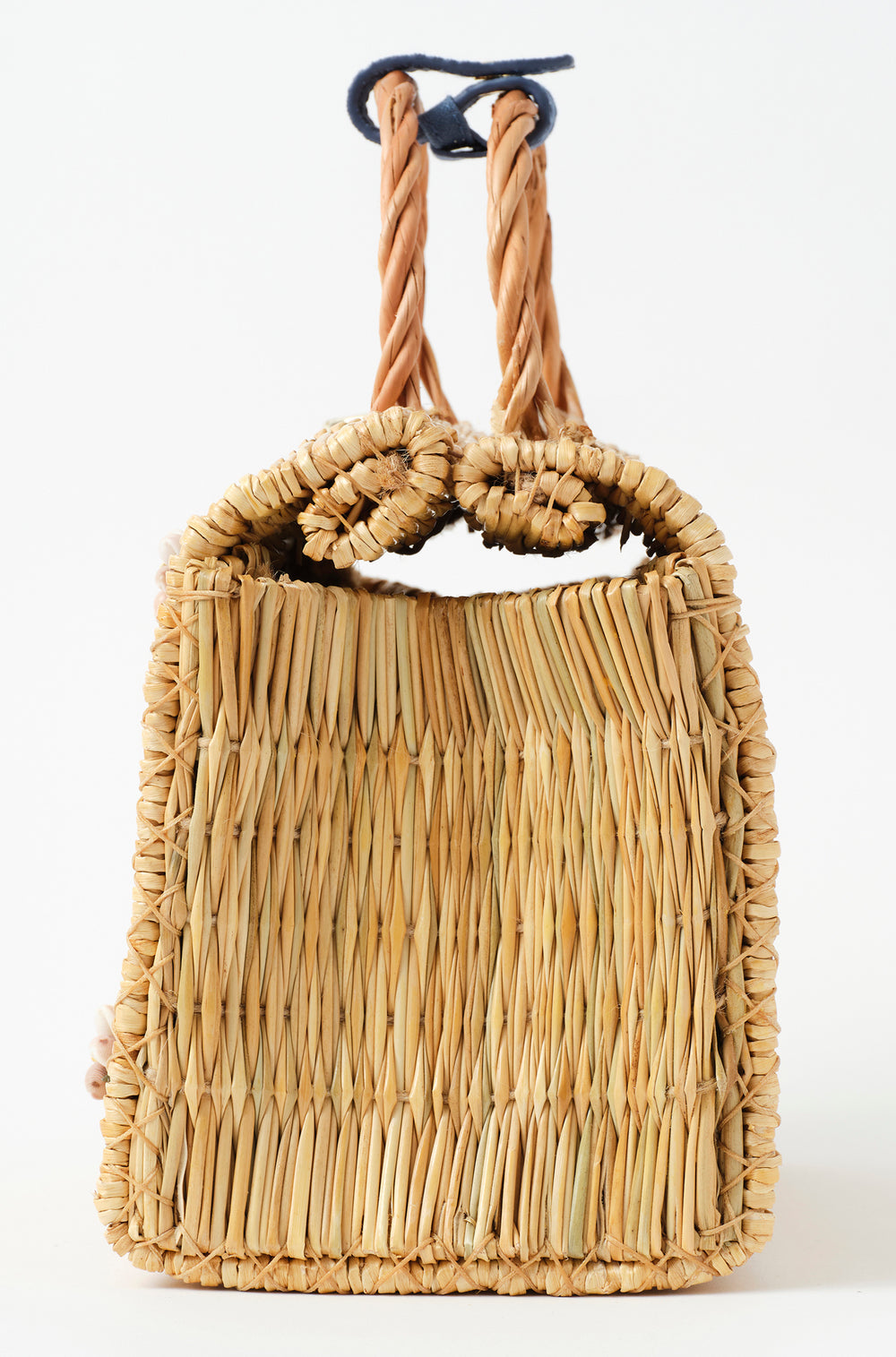 Shella Denim Classic basket bag by Heimat Atlantica, woven in Portugal from reed and finished in Spain with an Atlantic shell charm.