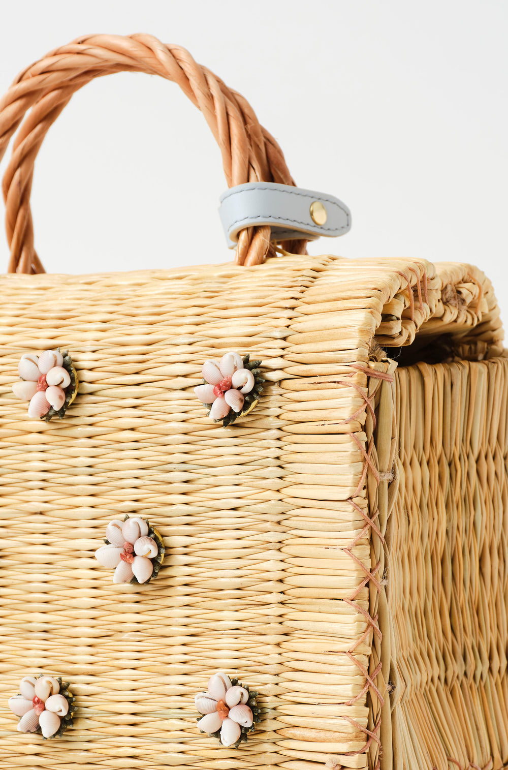 Shella basket bag by Heimat Atlantica photographed on the Atlantic coast between Spain and Portugal, celebrating shell craft, handmade tradition, and contemporary design detail of clouser.