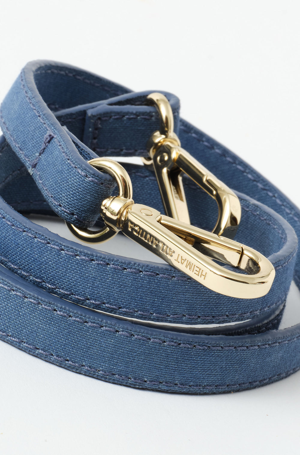 Strap in denim to hold the bag with buckel in gold and heimat atlantica branding