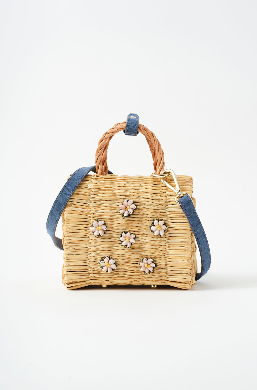 Mini Shella basket bag by Heimat Atlantica, handwoven in Portugal from reed and finished in Spain with an Atlantic shell detail. General view with Denim strap